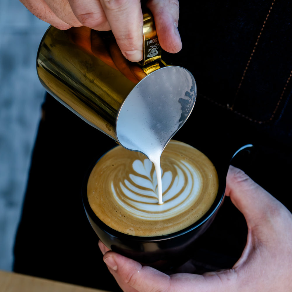 image of barista pouring latte