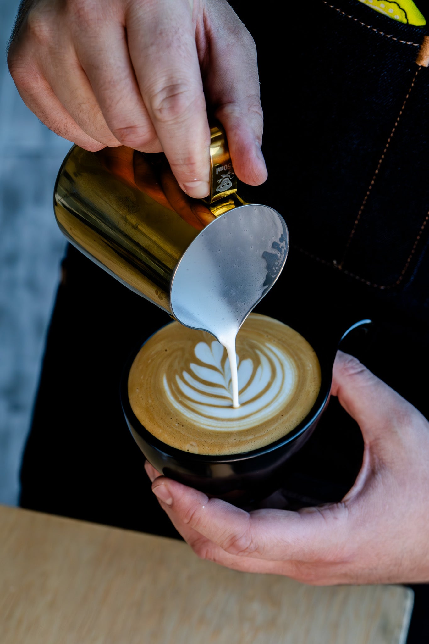 image of barista pouring latte