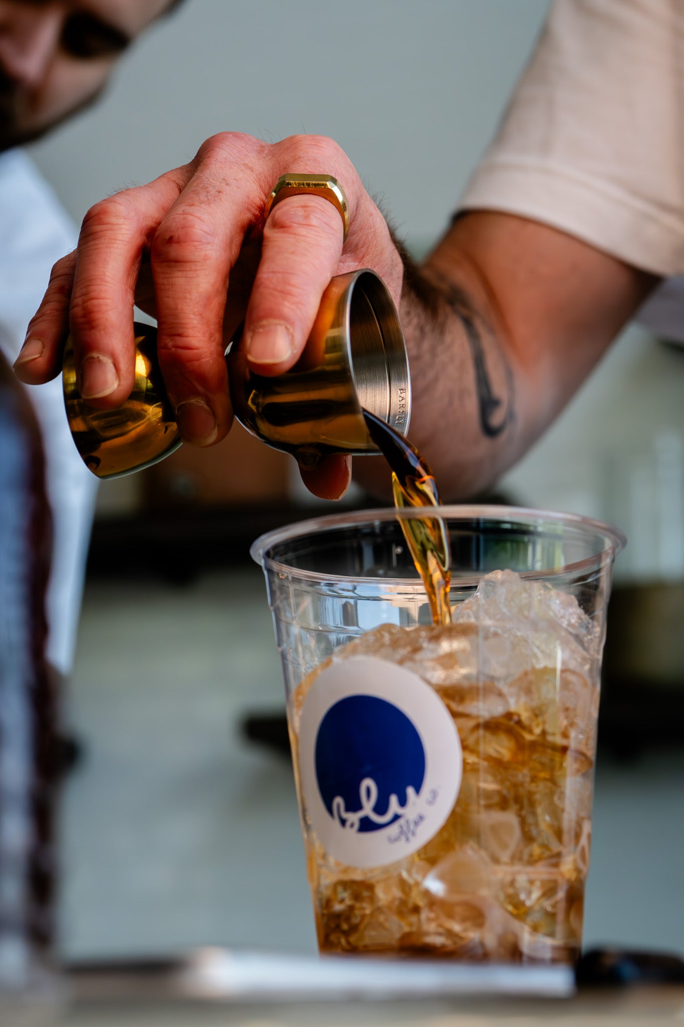 image of syrup being poured into iced latte